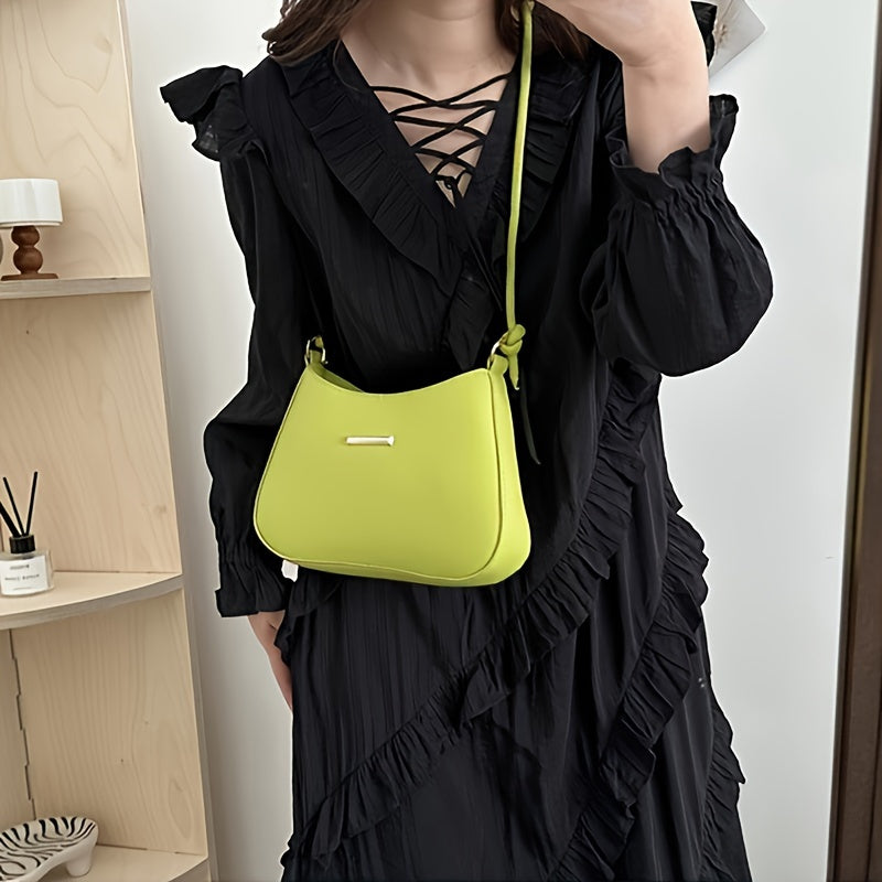 Black square handbag with zipper closure, crossbody style, edge paint detail.