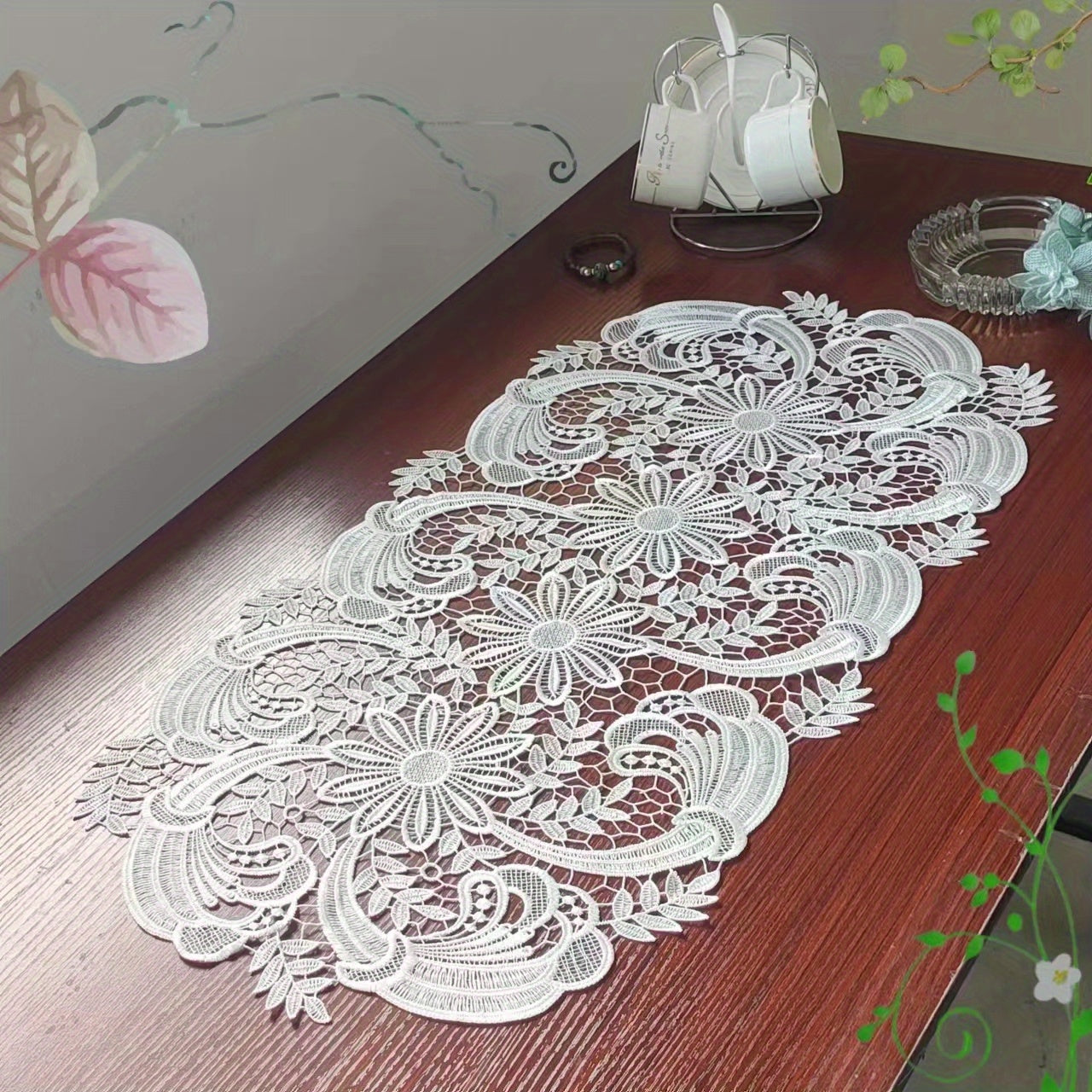 White velvet lace oval table runner with floral pattern, perfect for holiday table setting. Butterfly motif on decorative fabric for dining and home decor.