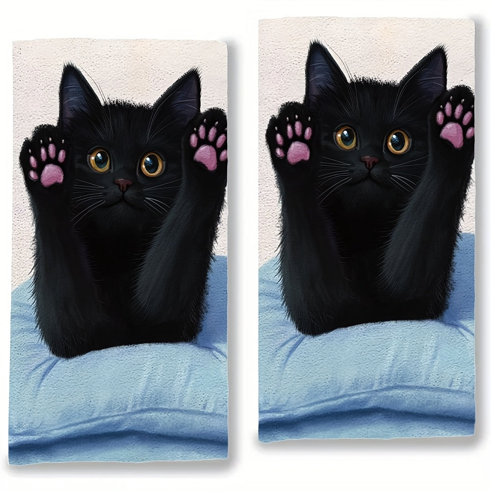 This pair of ultra-soft kitchen towels showcases a black cat stretching on a pillow, with its front paws and pink claws on display. These highly absorbent dish towels are ideal for holiday decoration and can be easily machine washed. The towels measure