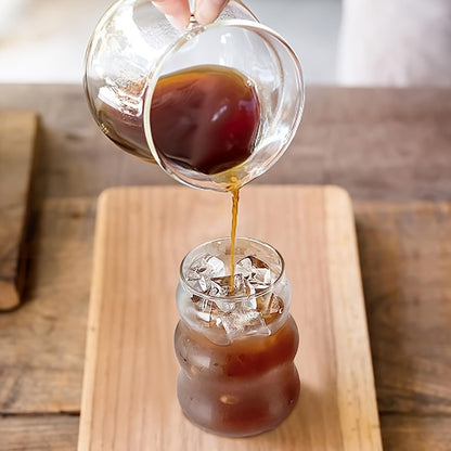 Ribbed glass cup with vintage design, ideal for multiple uses in kitchen and restaurant.