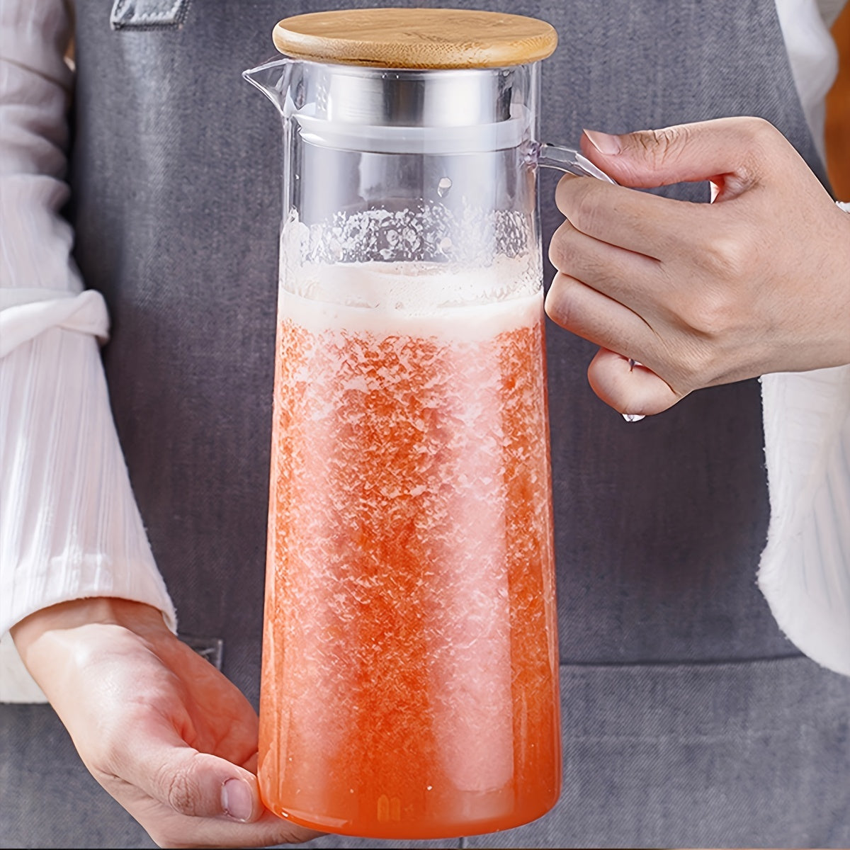 Large capacity ice bucket beverage pitcher made of durable and transparent polycarbonate with filter lid and easy pour spout for cold drinks, beer.