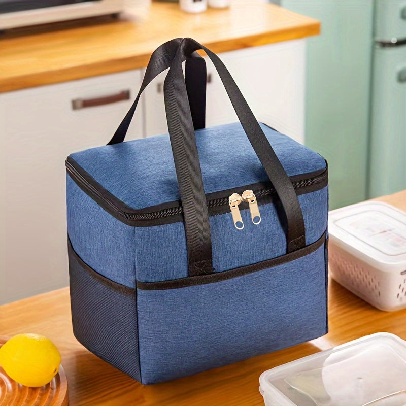 Insulated lunch bag with aluminum lining, made with double-layered Oxford fabric for a large capacity. Features front and side pockets, perfect for office, picnic, camping, or travel. Convenient and portable food storage option that is machine washable.