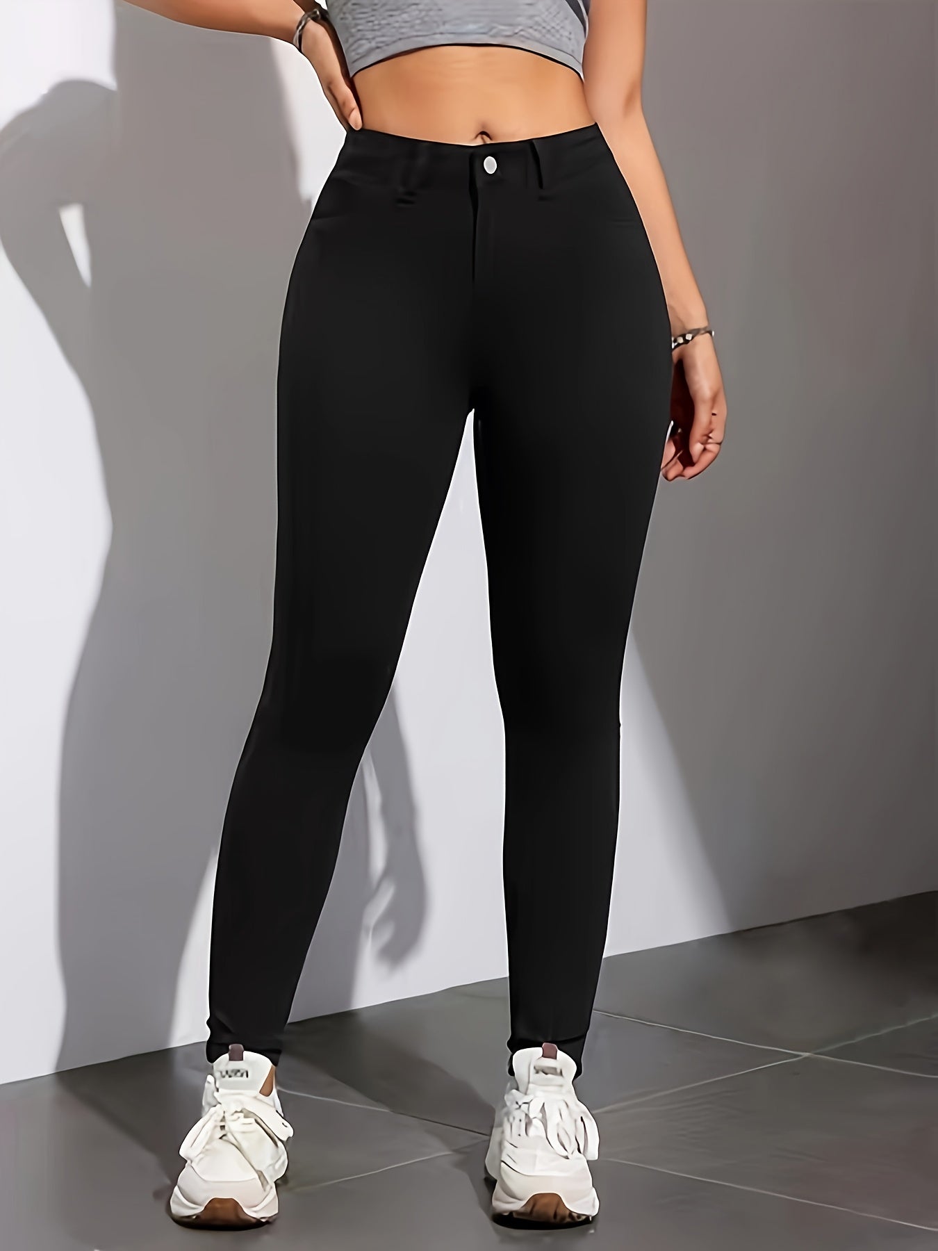 High-waist, skinny jeans in chic black with casual stretch denim, solid color, long length, trapeze hem, and zipper fly. Suitable for all seasons.