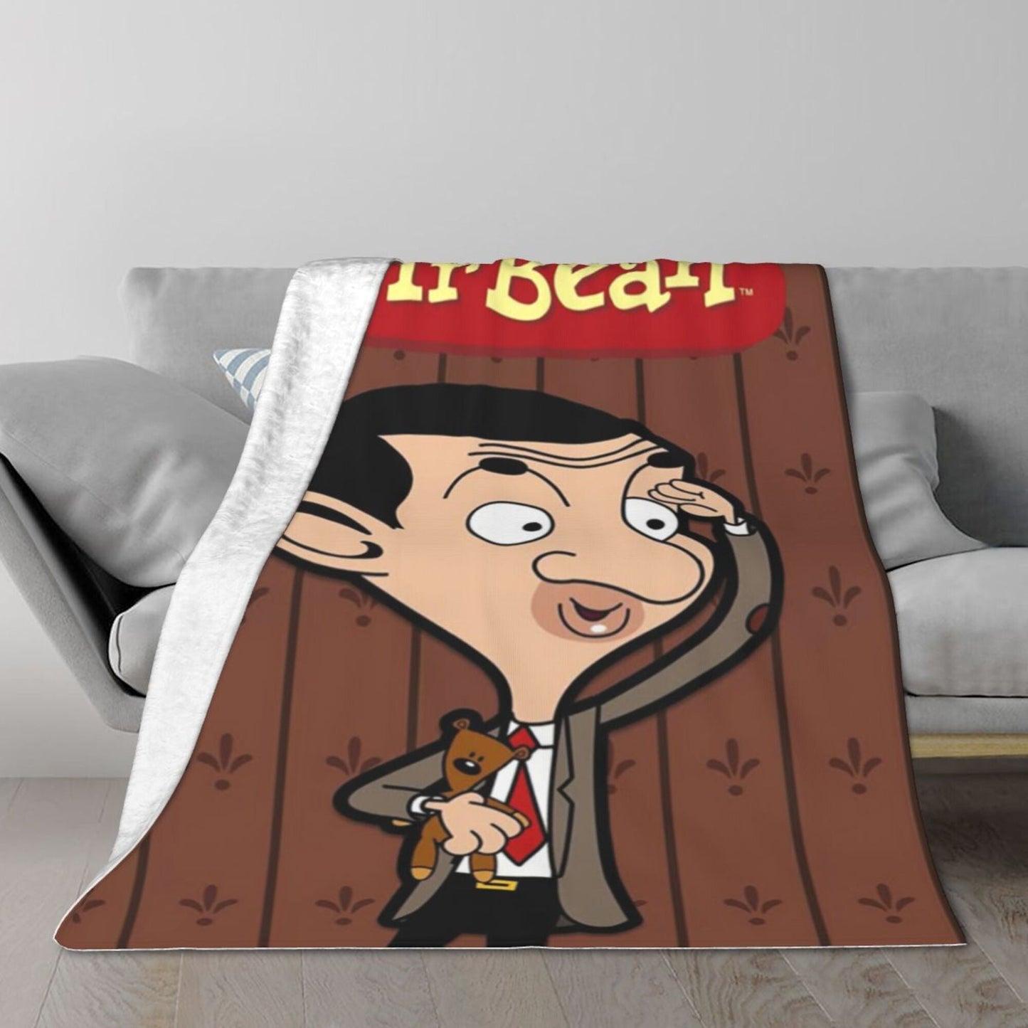 Soft, lightweight Mr. Bean flannel nap blanket, the perfect stress-relief throw for office naps. Ideal for all seasons, this cozy cartoon blanket is made of polyester and makes a great gift for friends and family. It features a digital print, making it a