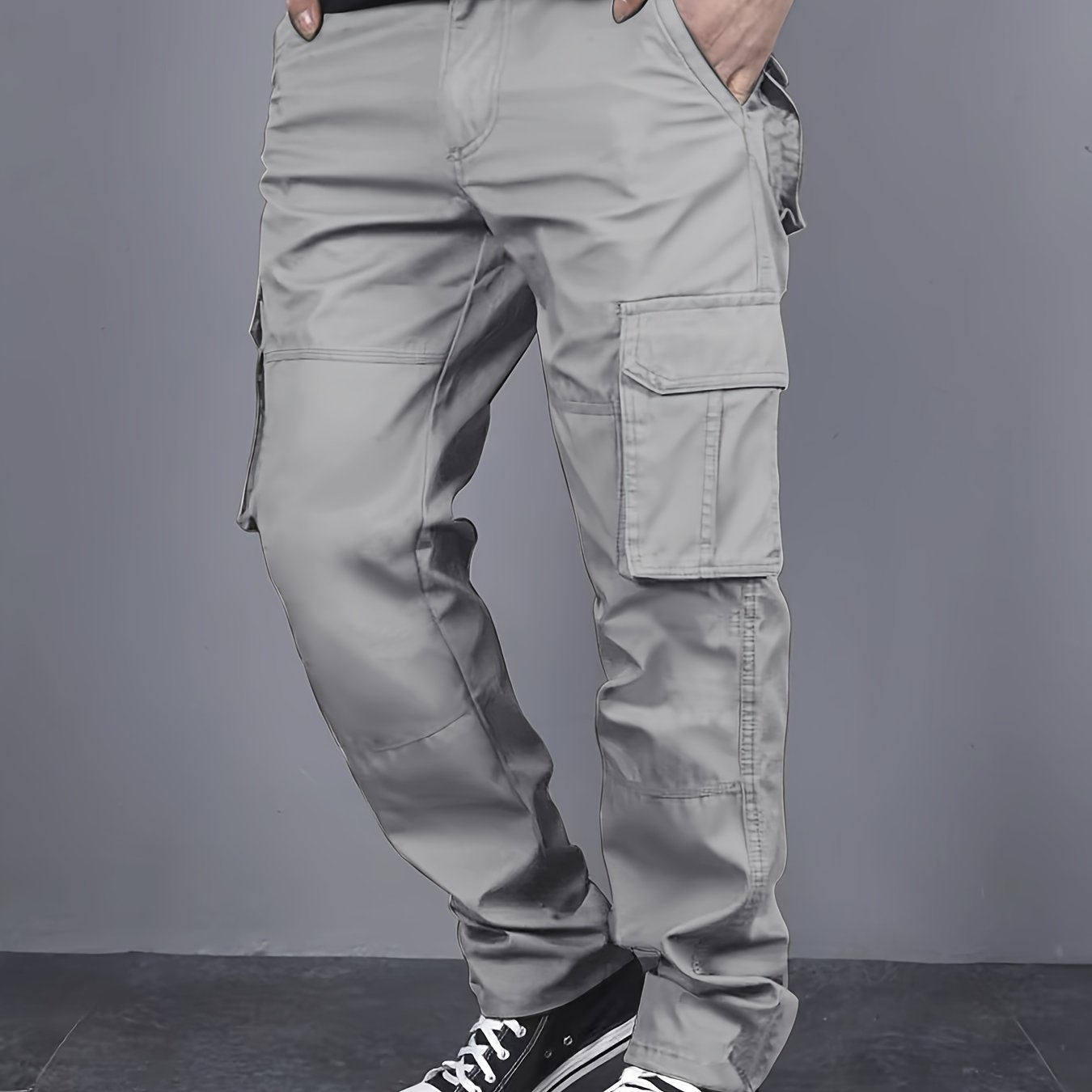 Solid color cargo pants with multiple flap pockets and a drawstring waistband, perfect for outdoor activities like hiking, fishing, and camping.