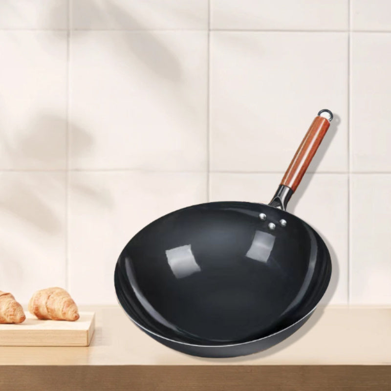 This essential item for home kitchens is the 1-piece Rust-Resistant Cast Iron Skillet with Wooden Handle in Black. With a round bottom design, this wok is perfect for gas stoves and is available in multiple sizes. Made of stainless steel and free of any