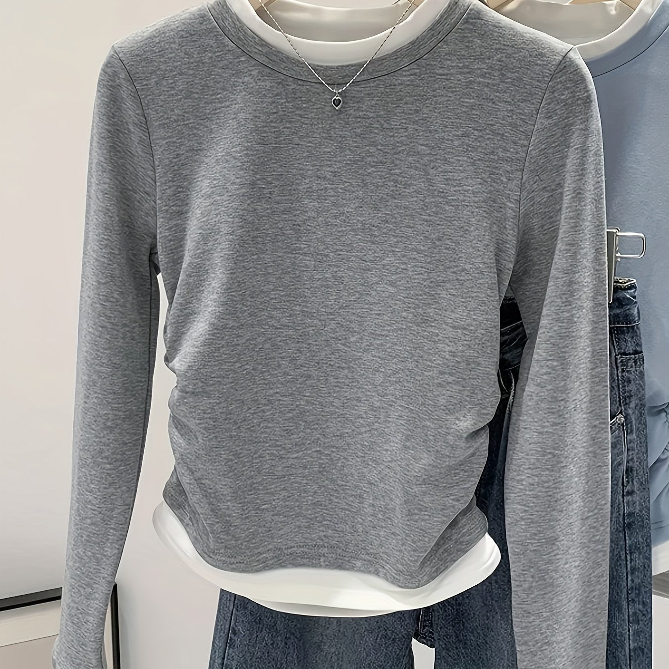 Women's slim fit knit T-shirt with ruched detail and contrast collar, suitable for all seasons.