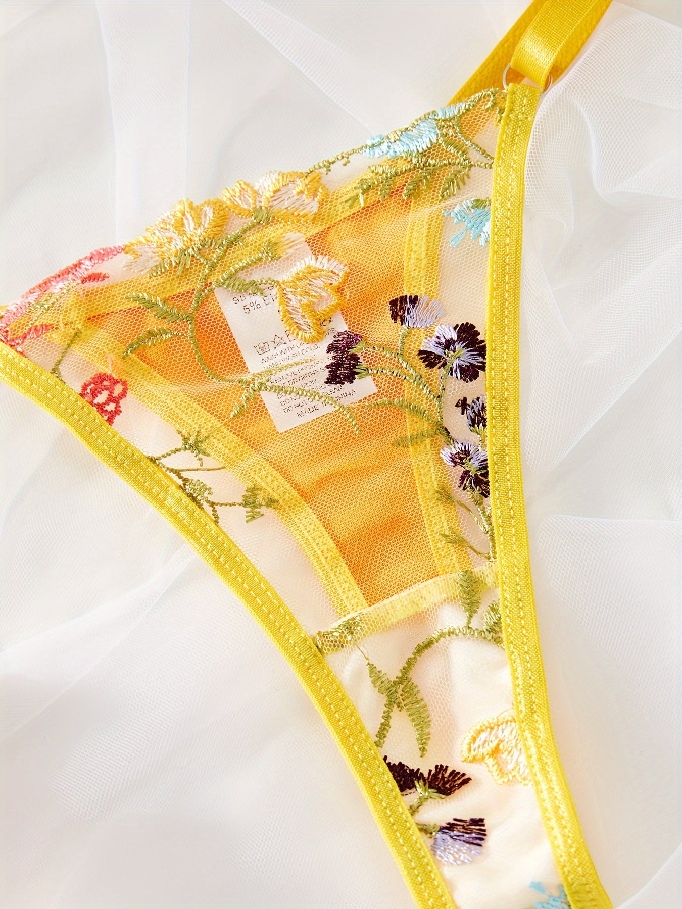 Yellow semi-sheer mesh lingerie set with floral embroidery, including bra and thong. Perfect for a stylish and sexy look.