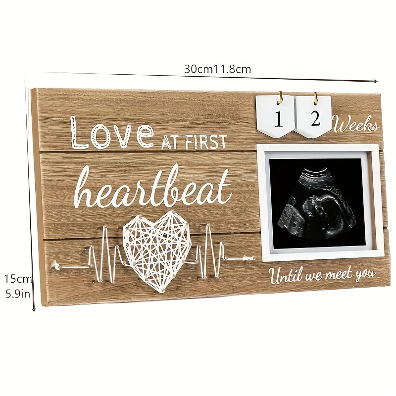 Baby countdown photo frame made of wood featuring a heartbeat design. This newborn keepsake frame is suitable for children aged 0-3 years and comes with interchangeable week tracker blocks.