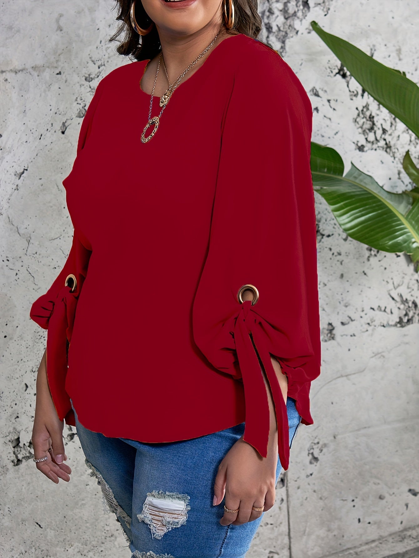 Plus size women's casual top with solid colors, lantern sleeves, round neck, round hem, and knot detail.