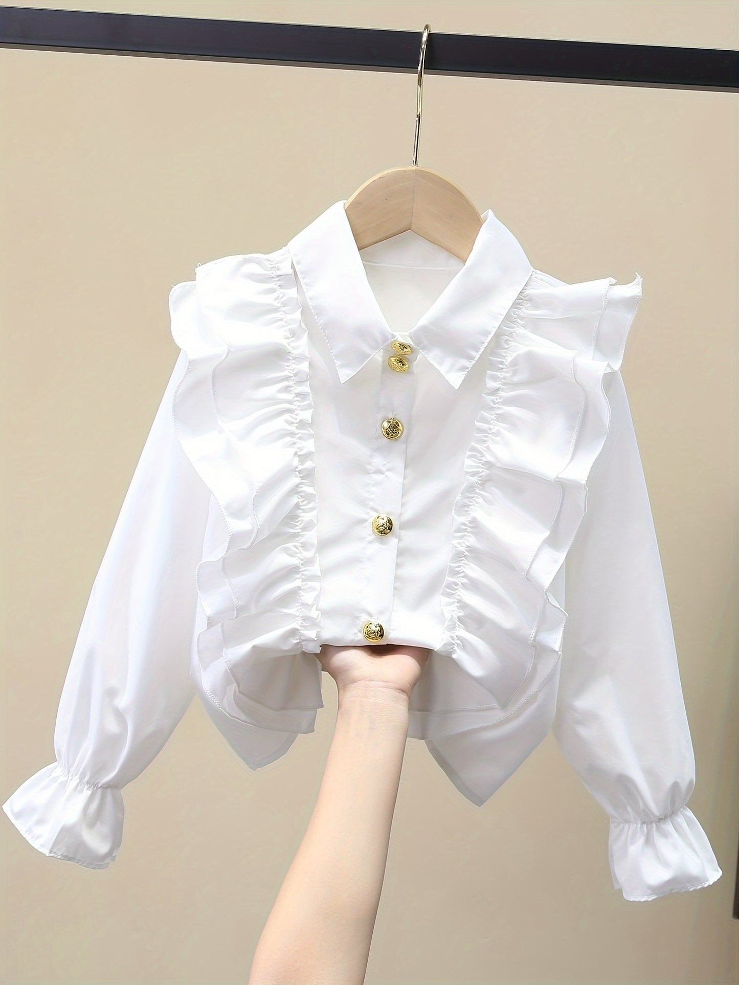 Stylish girls' long-sleeve dress shirt with ruffled cuffs and metal buttons - perfect for school uniforms or fashionable looks.