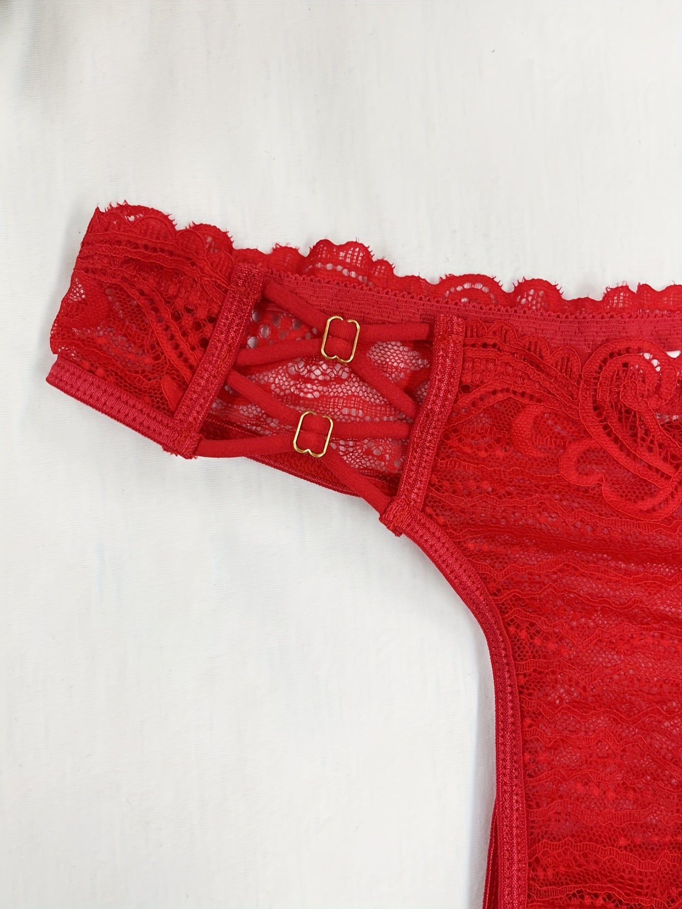 Red lace thong panties for women with floral pattern and scalloped trim. Made of breathable polyester blend that is semi-sheer and hand washable.