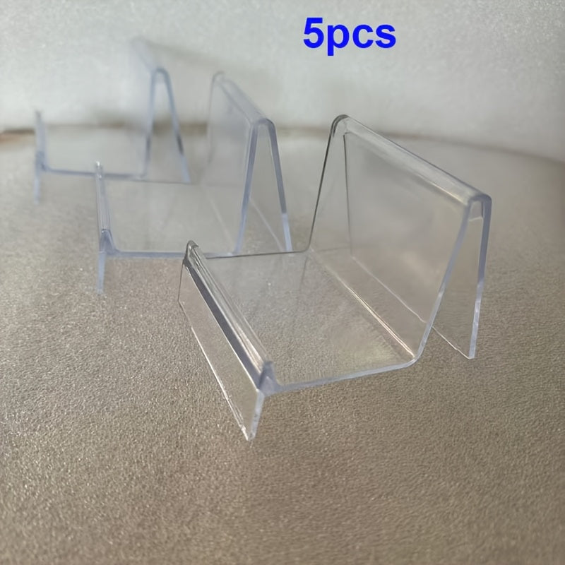 Clear Purse Display Stand, available in either a 5 or 10 piece set. Made from acrylic, this stand is perfect for showcasing wallets, glasses, clutches, handbags, or garage kits on shelves, in closets, or on retail countertops. Stay organized with this