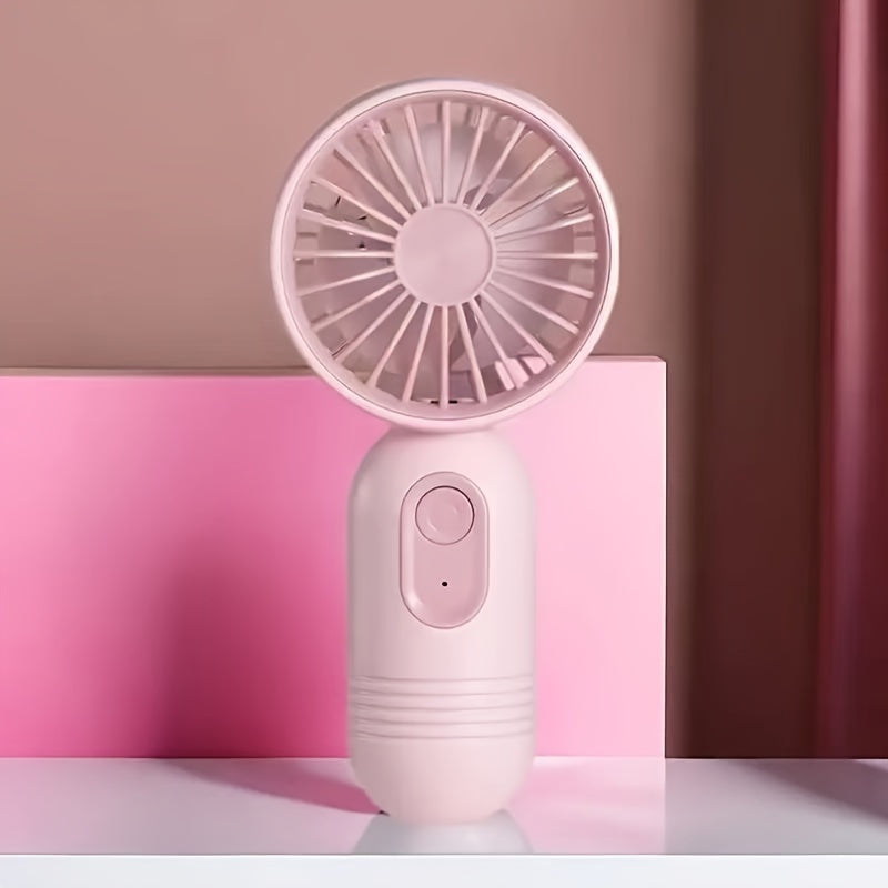 Small portable fan that is handheld and rechargeable via USB, light weight and quiet for use on desk or while traveling, ideal gift for the summer season.