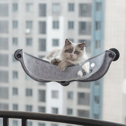 Crescent-shaped suction cup cat hammock for small and medium cats to sleep in sunlight.