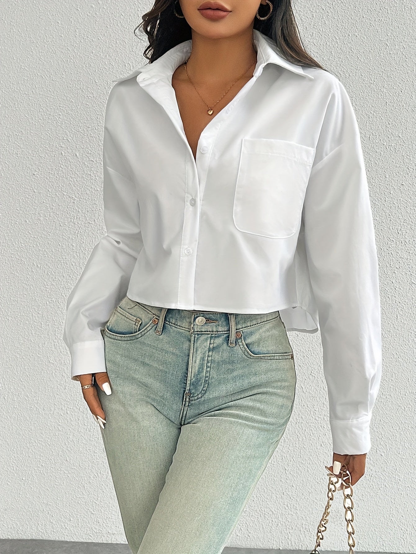 Stylish white casual shirt for women, drop shoulder, long sleeve, short style with pocket, button-up, made of 100% polyester, machine washable, ideal for casual wear.