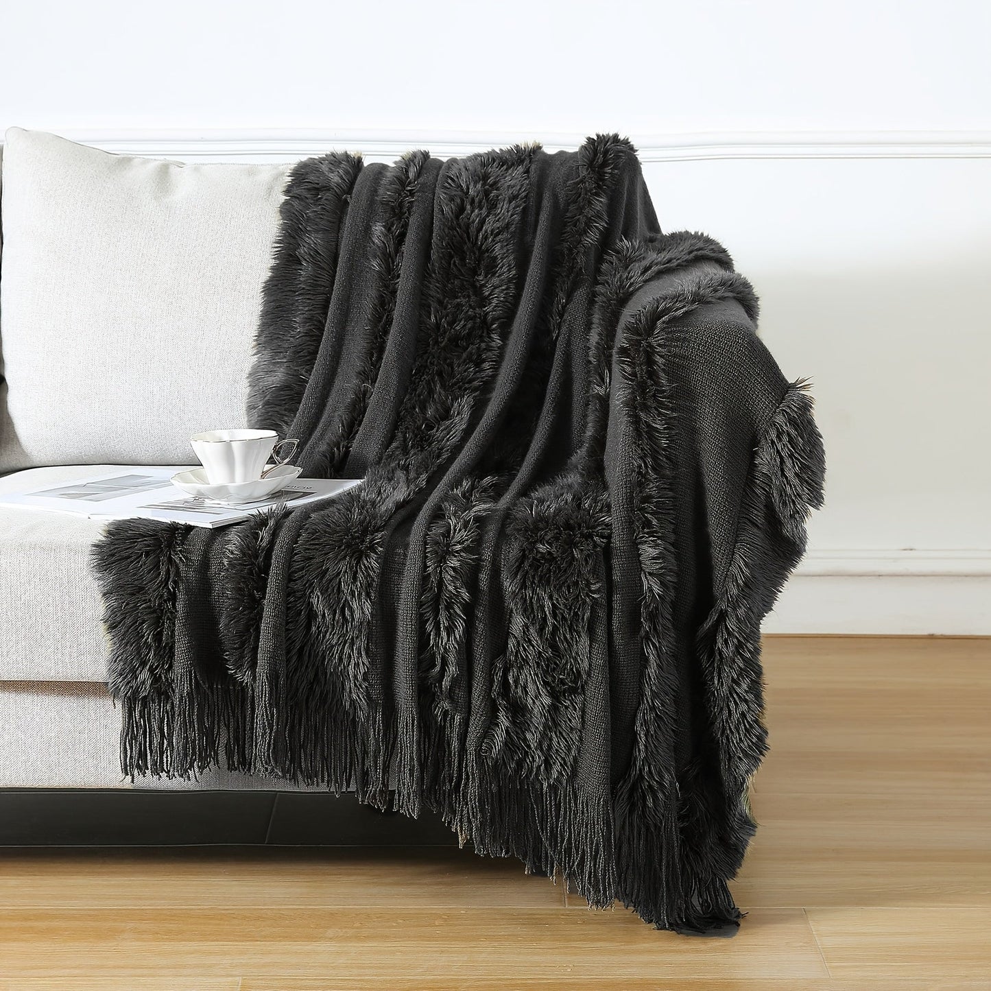 Stay cozy with this contemporary acrylic chunky knit throw blanket featuring tassels. With its solid pattern, lightweight plush texture, and machine washable design, this all-season throw is perfect for adding a touch of style and comfort to your couch