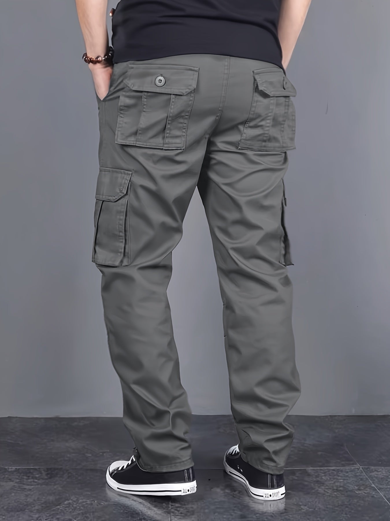 Solid color cargo pants with multiple flap pockets and a drawstring waistband, perfect for outdoor activities like hiking, fishing, and camping.