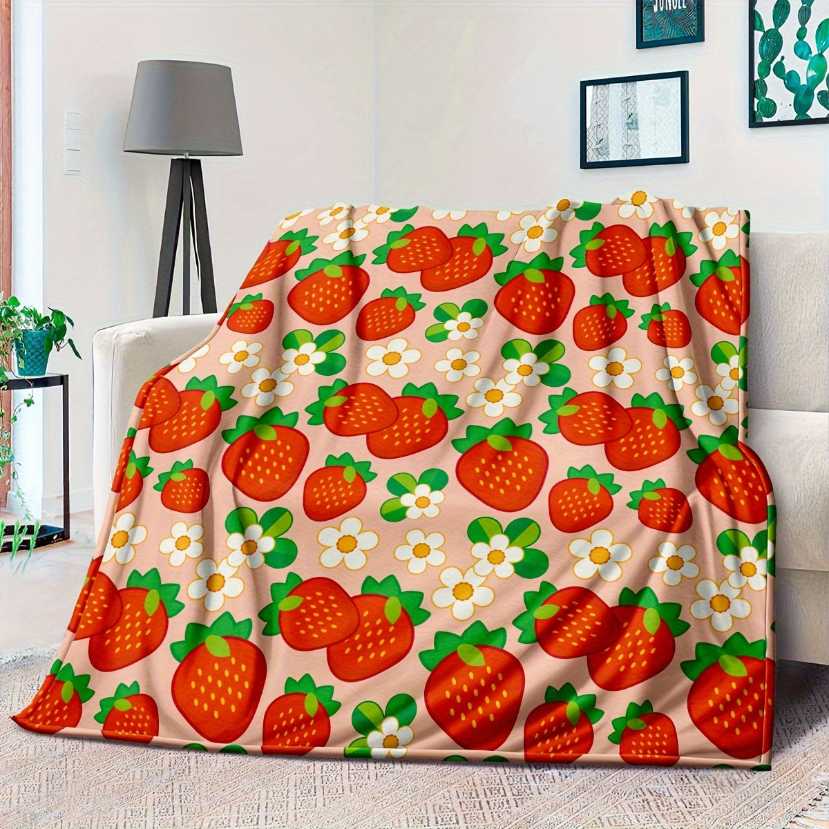 One piece of a cozy, all-season microfiber throw blanket in a rustic style, featuring a charming strawberry and flower pattern. This woven fruit-themed gift blanket is perfect for women.