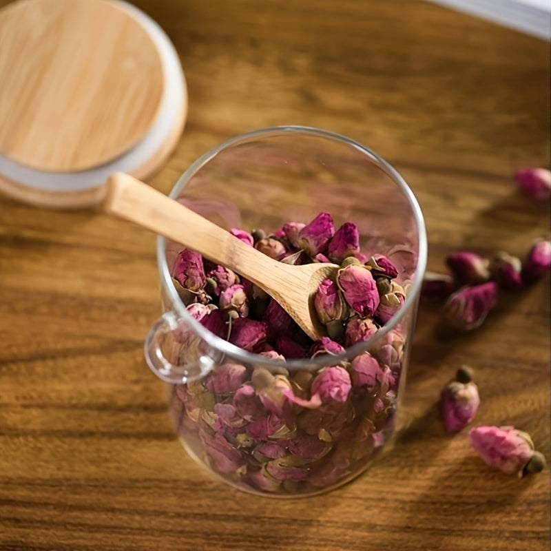 Glass airtight jars with bamboo lids and wooden spoons are versatile round food storage containers for the kitchen. They are reusable, easy to hand wash, and feature a flip top closure. Perfect for storing sugar, spices, and dry goods.