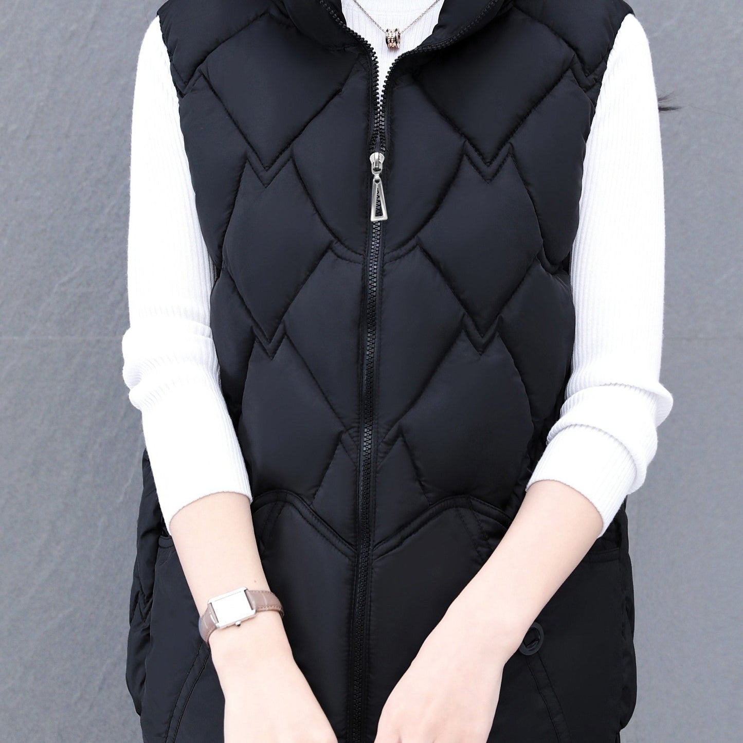 Women's polyester vest with quilted stand collar, zipper closure, pleated hem, and loose fit. Ideal for fall/winter casual wear with a Middle Eastern style.