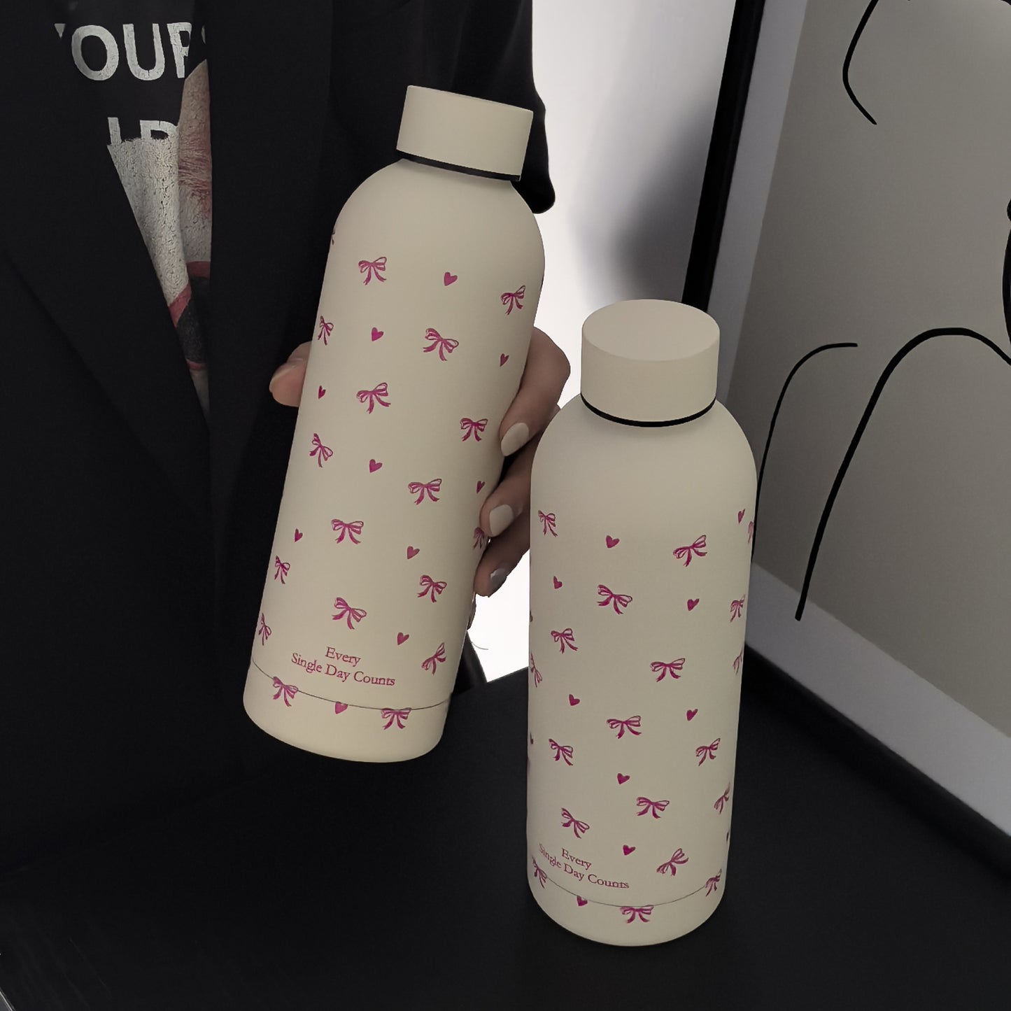 Insulated stainless steel water bottle with bowknot and heart design, perfect for travel, gym, outdoor, and car use. BPA-free and hand wash only.