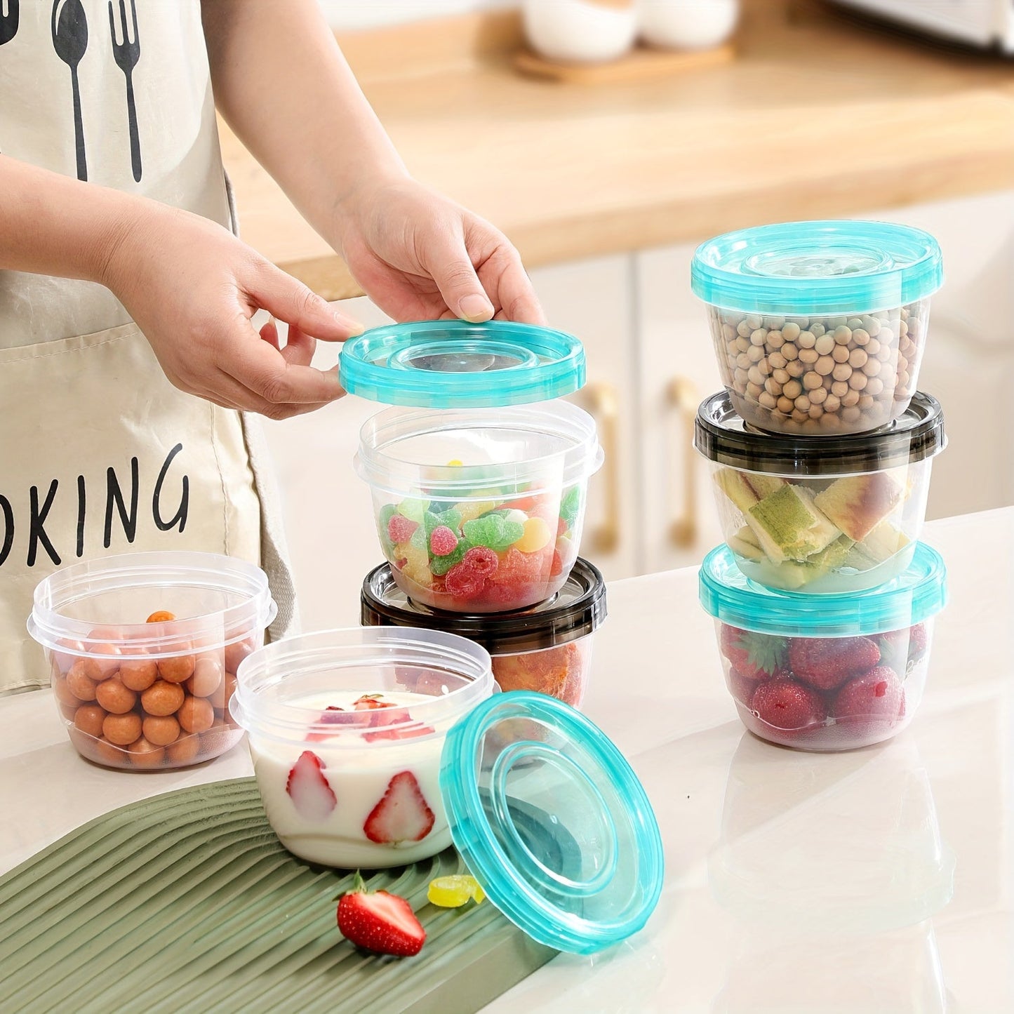 Two pieces of transparent food storage containers with blue lids - microwave safe and freshness preserving round boxes for storing grains, nuts, fruits, and more - perfect for use in home kitchens.