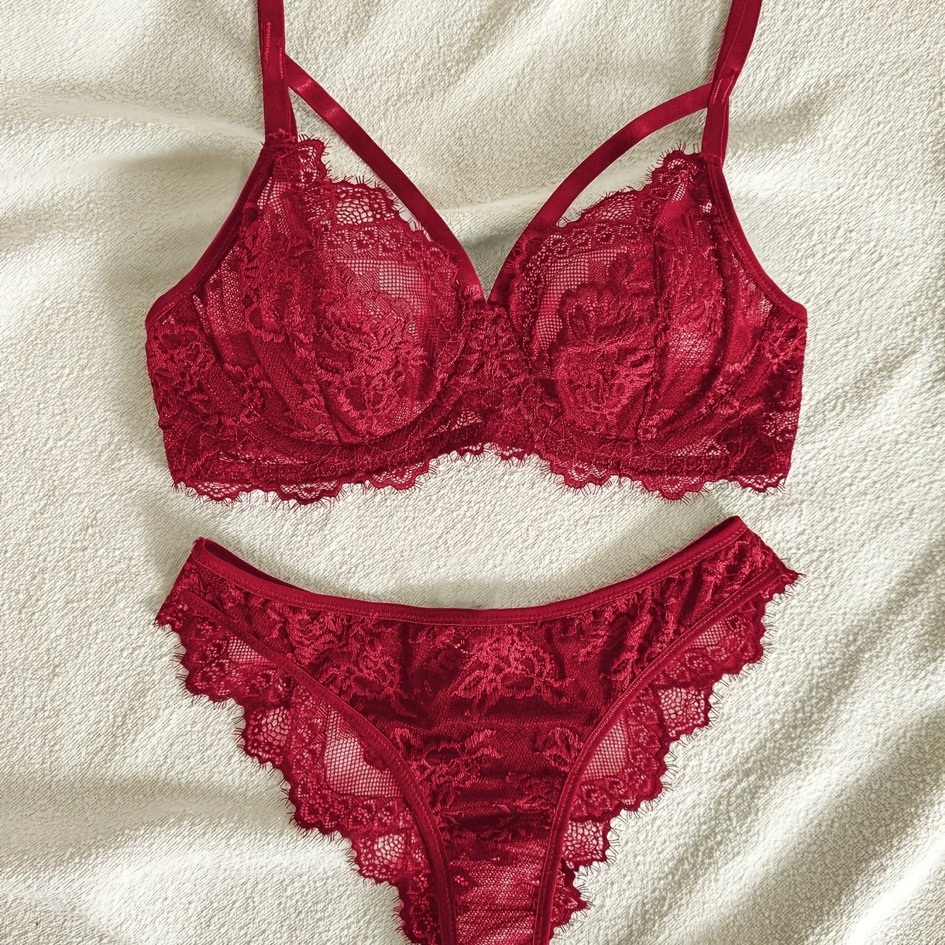 Women's semi-sheer lace lingerie set with underwire bra, mid-rise panties, and no padding.