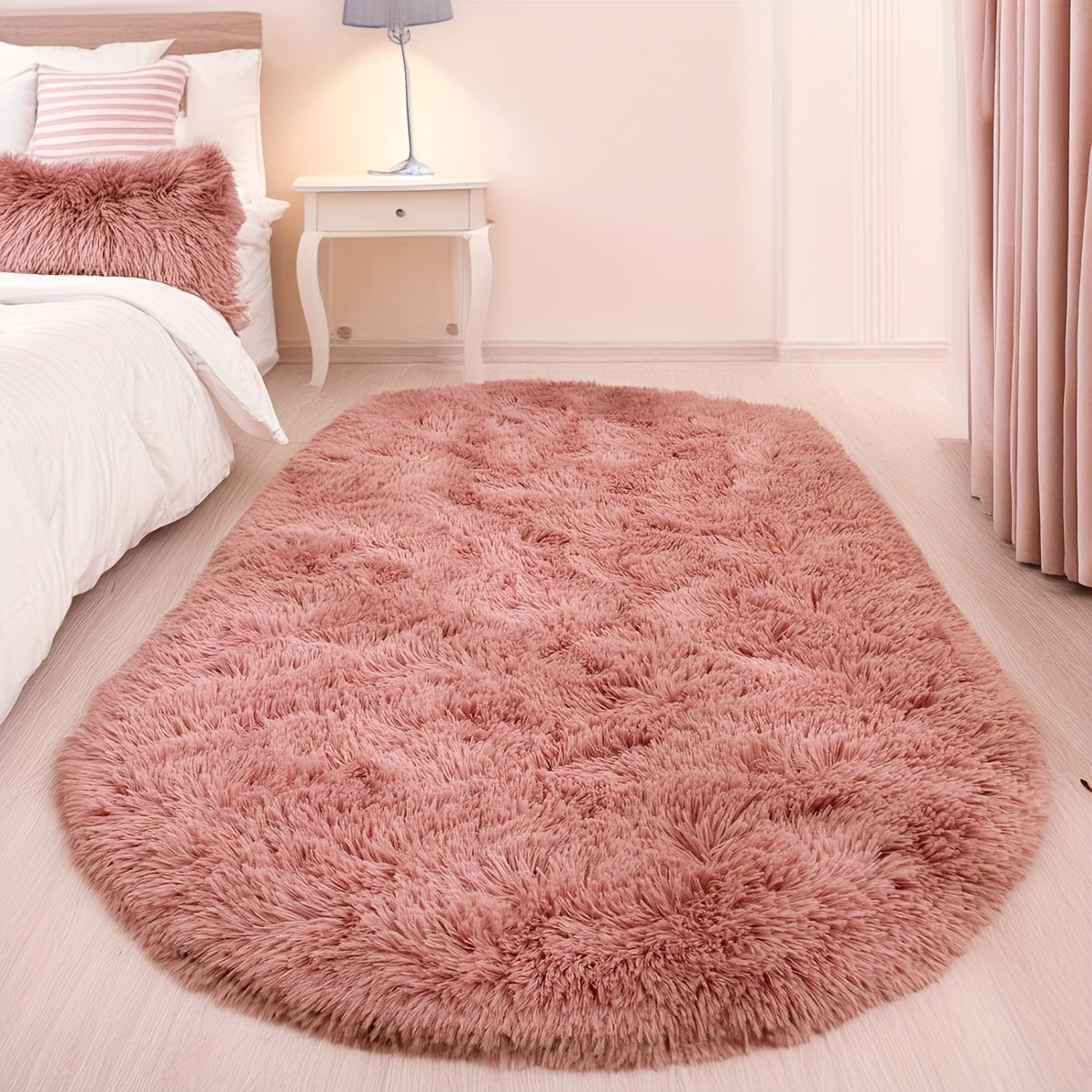 Soft and fluffy oval shaggy area rug, perfect for bedroom or living room. Made with skin-friendly thickened sponge and tufted polyester material. Durable and easy to maintain. Adds decorative touch to indoor spaces such as sofa, bedside, playroom, or