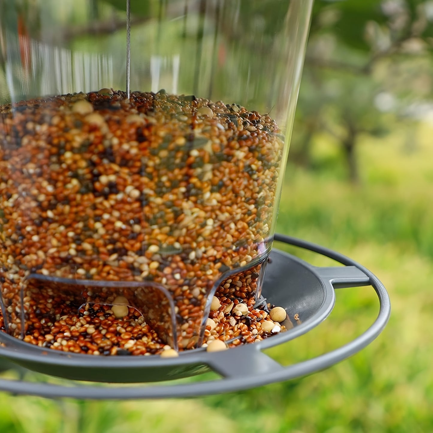 Outdoor hanging bird feeder with automatic features for hummingbirds and wild birds in your garden yard.