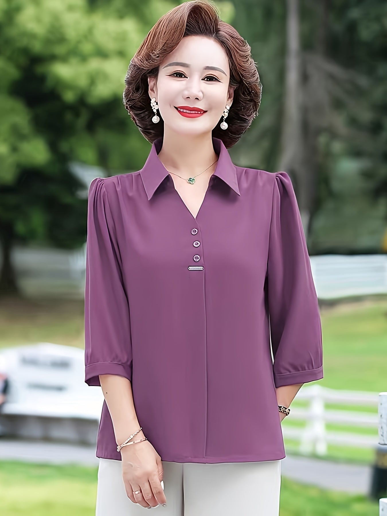 Stylish purple chiffon blouse for women with 3/4 sleeves, slimming fit, and decorative buttons. Made of lightweight polyester-elastane blend, perfect for spring, summer, and fall. Features