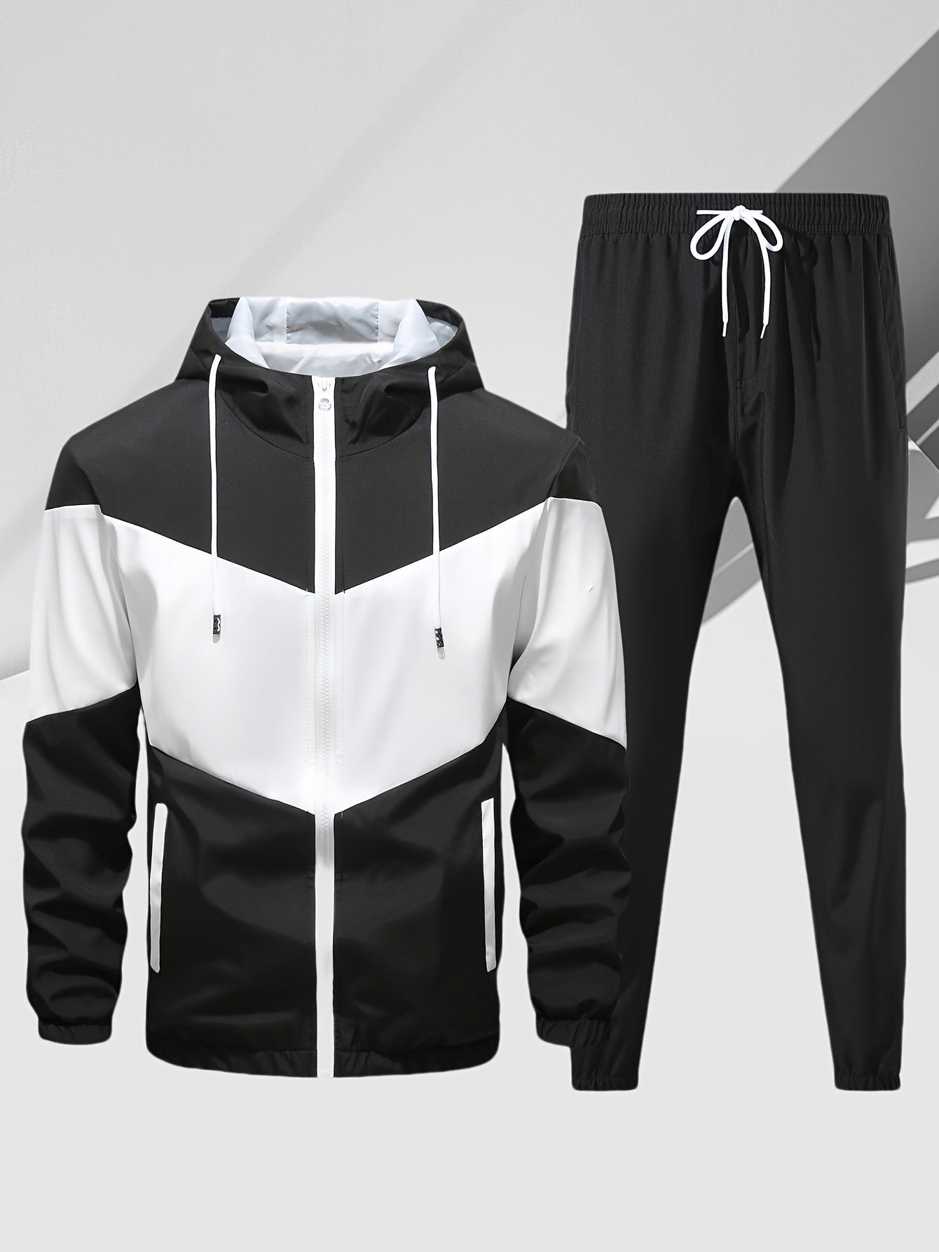 Men's casual 2-piece outfit with a stylish color block zip up hooded jacket and breathable drawstring pants.