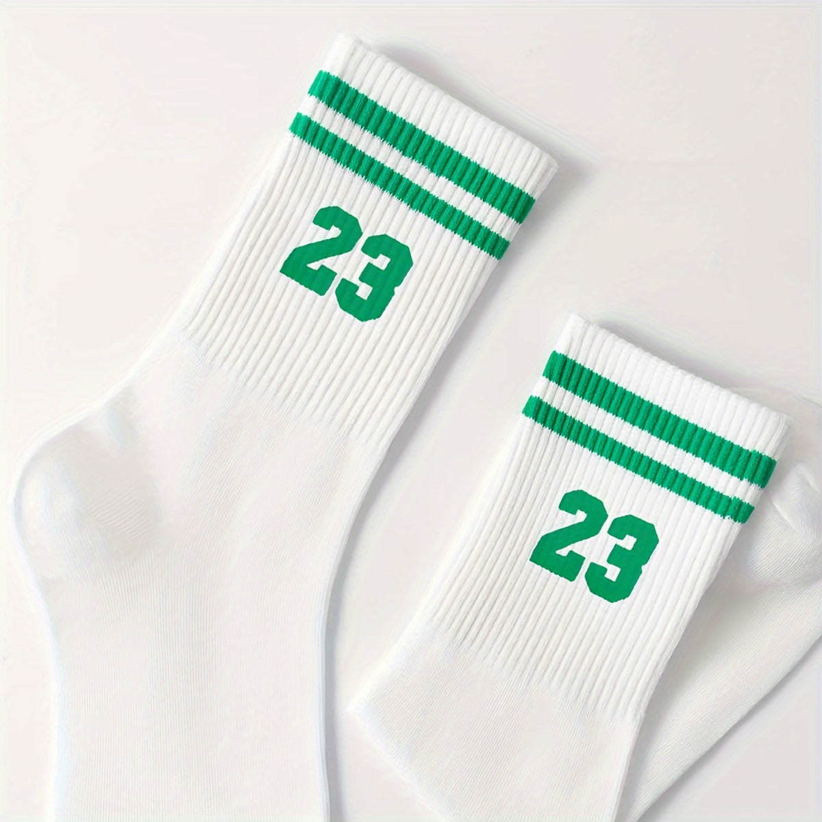 Men's athletic mid-calf socks with striped pattern featuring number 23. Made of 95% polyester and 5% spandex. Hand wash only.