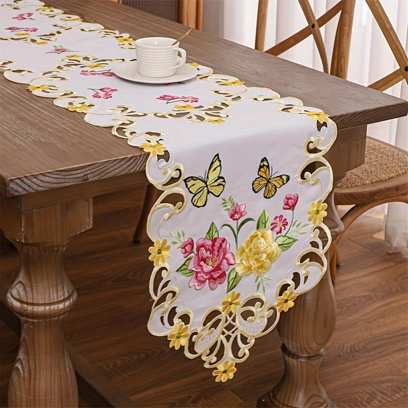 Elegant polyester table runner with hand-cut embroidered flowers and butterflies, perfect for home decor, restaurants, picnics, and parties. White base with vibrant floral patterns.