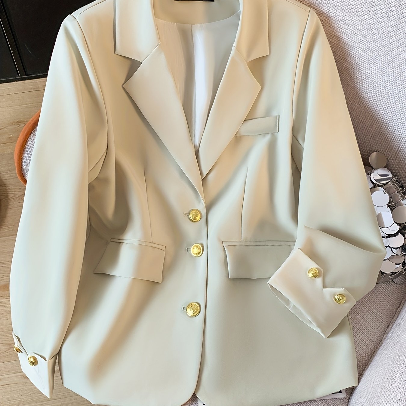 Stylish light blue blazer with golden button details for women, ideal for work in spring and fall.