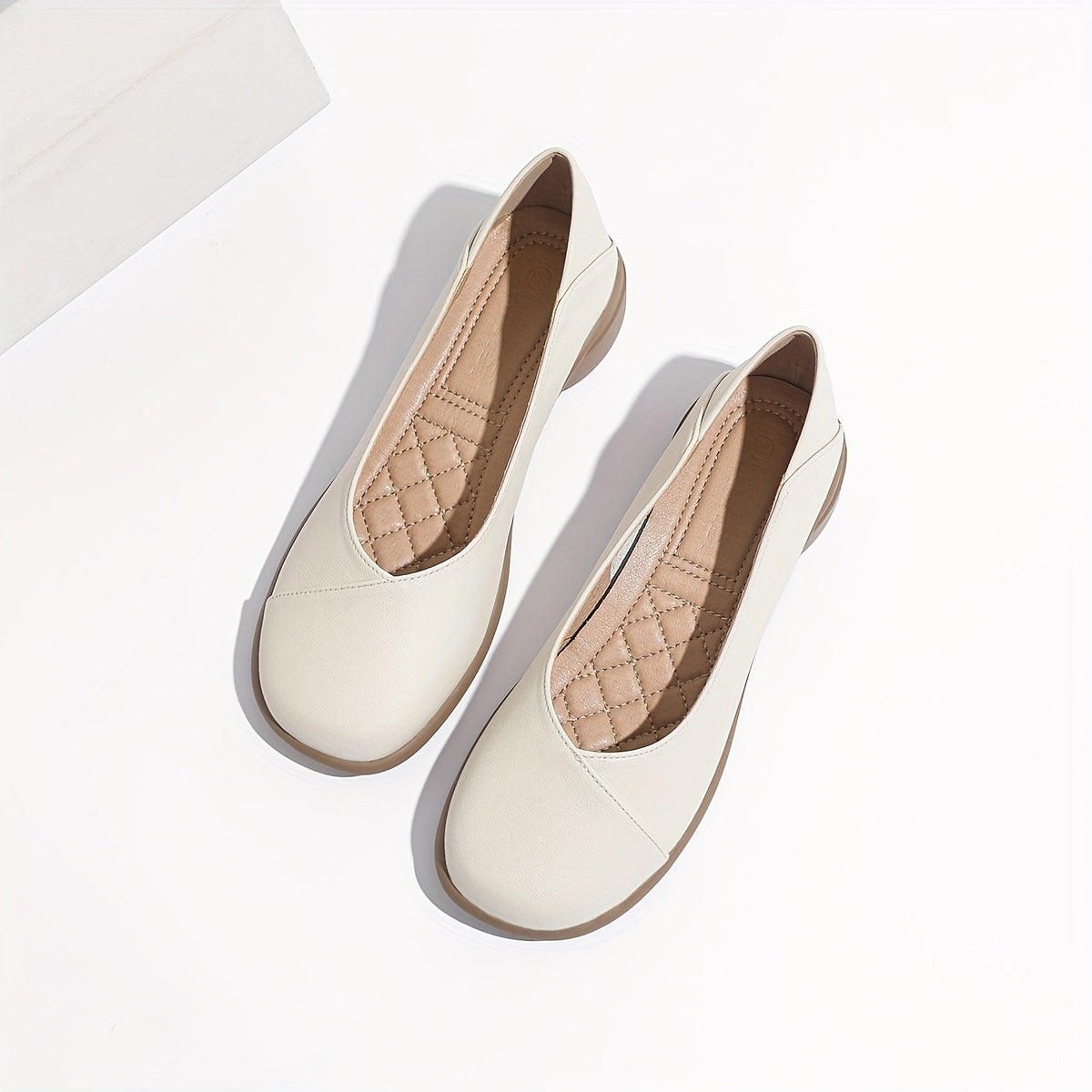 Stylish white low heel flats with all-day comfort for work.