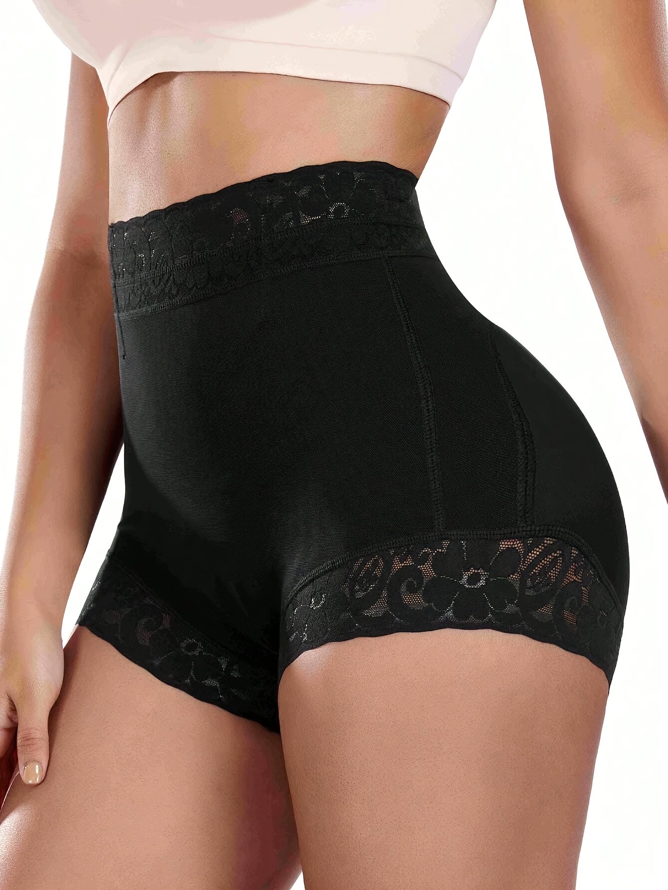 High-waist black shaping shorts with lace detail for tummy control and butt lifting. Made of stretchy nylon and elastane blend. Hand washable with smooth finish. Mid-thigh length and high