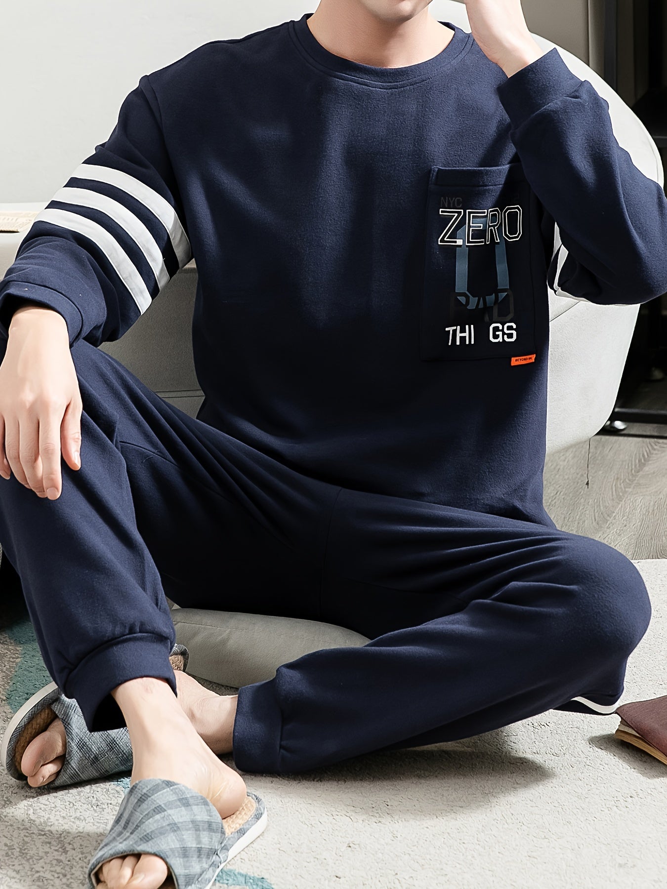 Casual cotton pajamas set for men with letter graphic print, long sleeve crew neck top with chest pocket and loose pants. Suitable for spring and autumn.