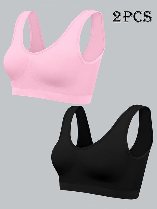 Two women's seamless, high elasticity sports bras made from solid color polyamide knit fabric. Offers high support and does not contain padding. Great for adult athletic activities.