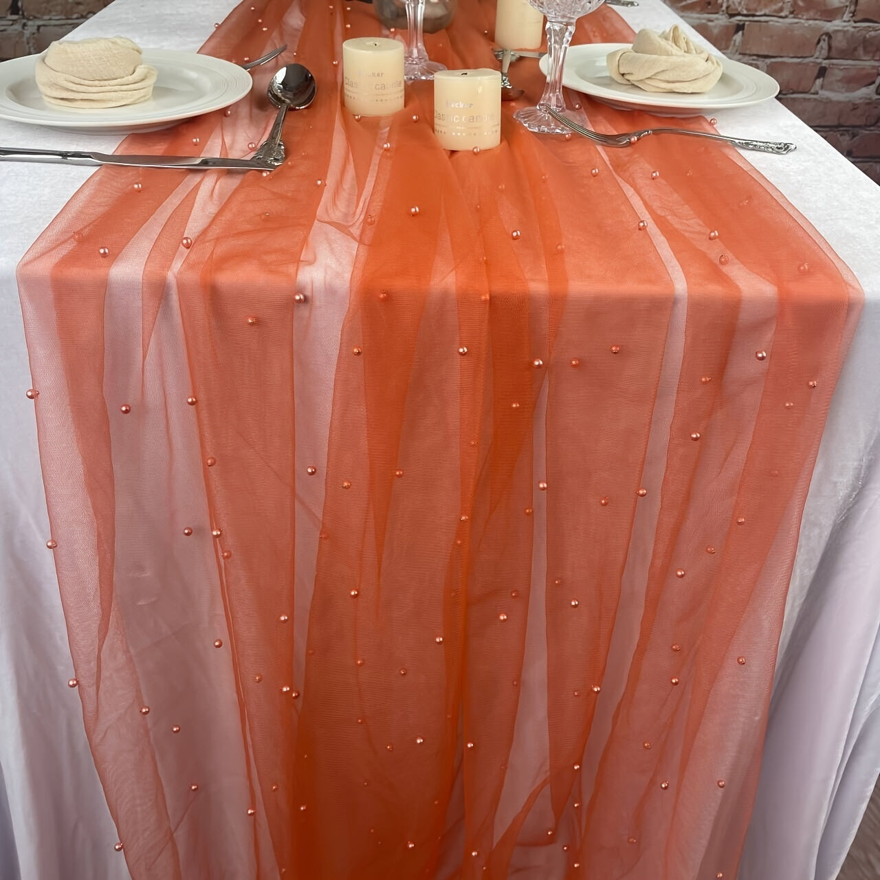 Elegant pearl bead tulle table runner, perfect for weddings and parties. Can also be used as a chair sash or backdrop drape. Made from 100% polyester fabric with delicate bead detailing.