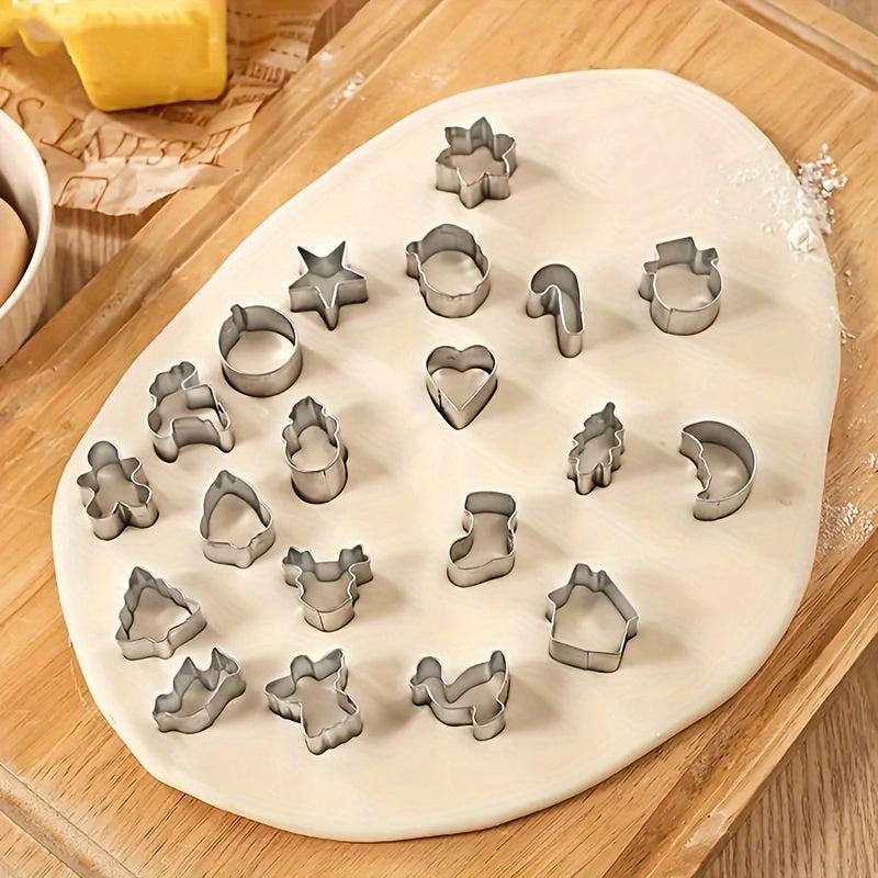 Set of 20 miniature Christmas cookie cutters made of stainless steel featuring Santa, reindeer, and snowman shapes. These baking molds are safe to use with food and perfect for making festive treats and holiday snacks.