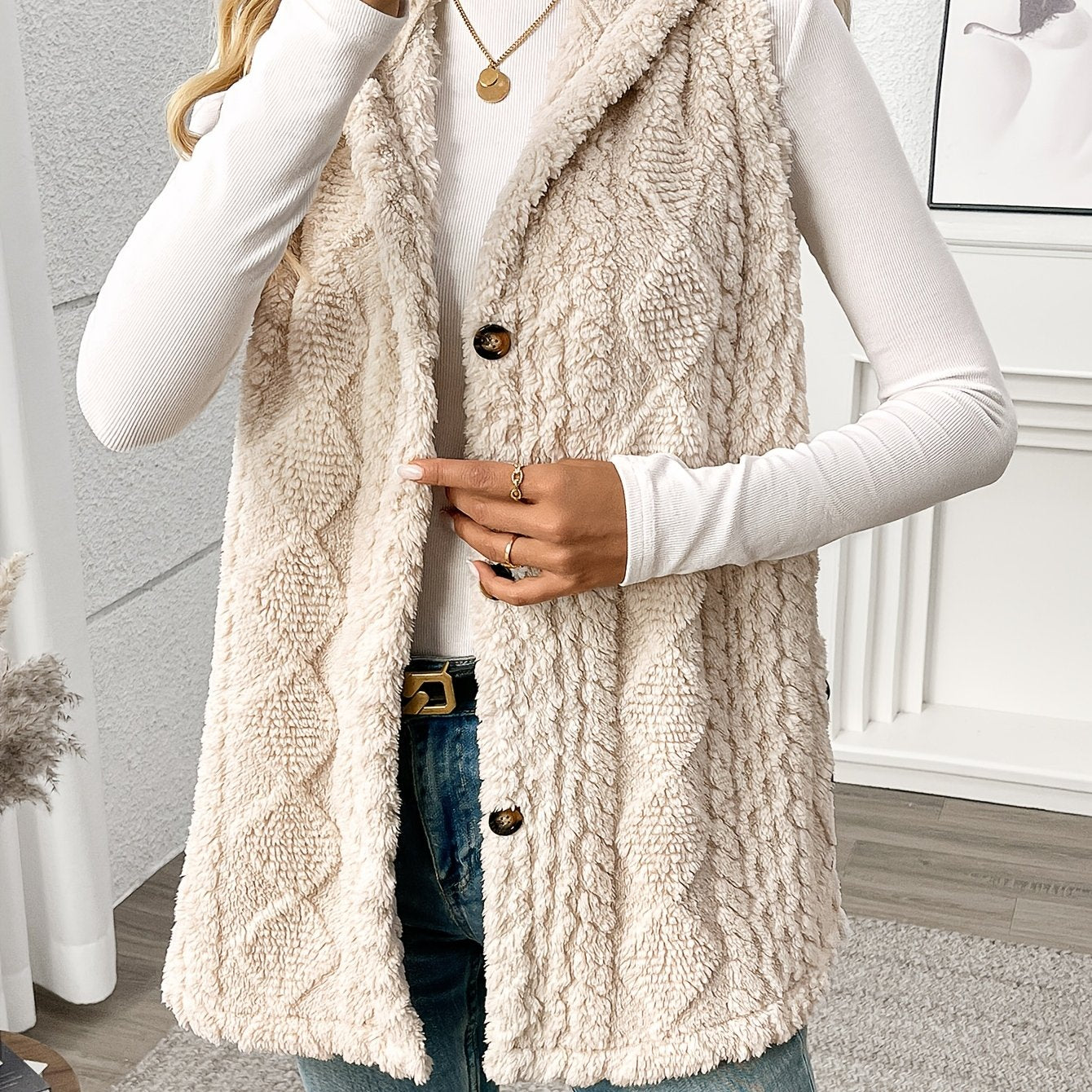 Sleek sleeveless hooded vest for women in solid color with plush texture and button detail. Machine washable and perfect for fall & winter.