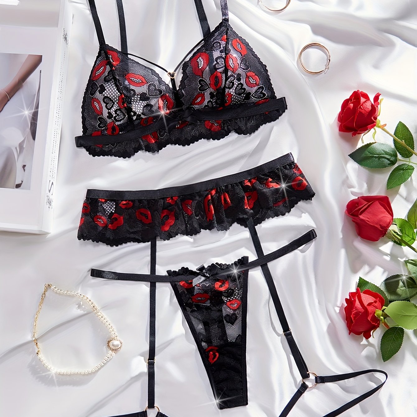 Lace lingerie set with red lips print and bow details. Includes transparent bra, G-string, and garter belt.