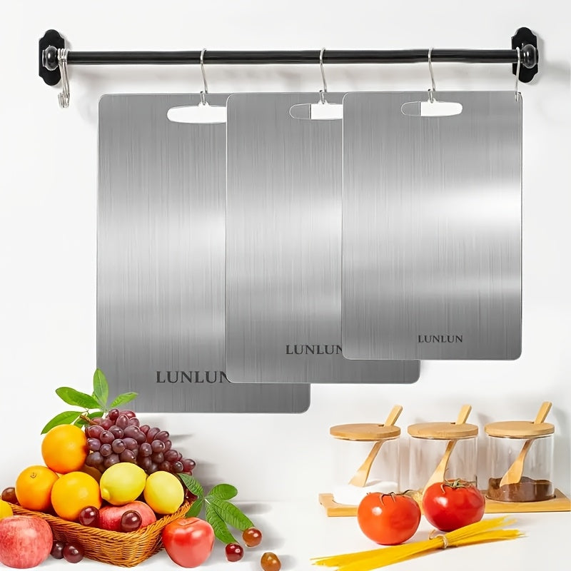 Metal chopping block for kitchen with carrying handle made of stainless steel - sturdy, versatile, and food-safe cutting surface for preparing fruits and vegetables