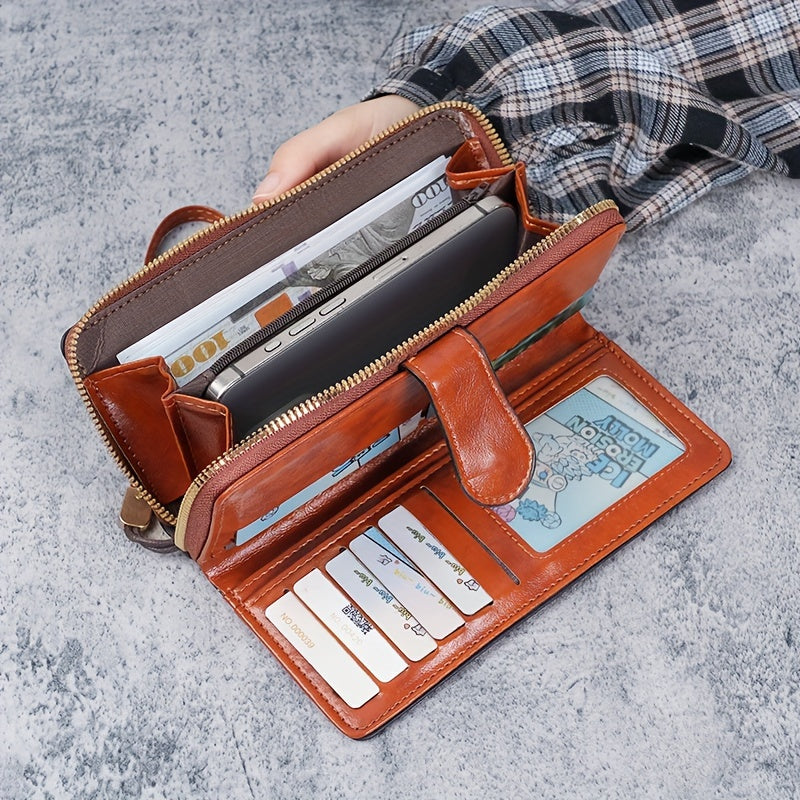 Black faux leather long clutch wallet with wristlet, ID card compartment, button closure, and edge paint. Dry clean only.