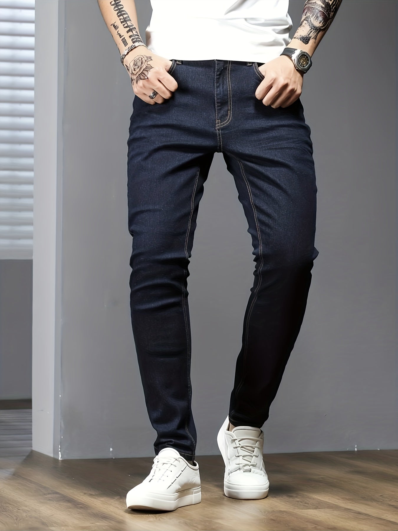 Men's slim fit jeans in solid color, made with stretch denim fabric and raw wash detail, suitable for all seasons.