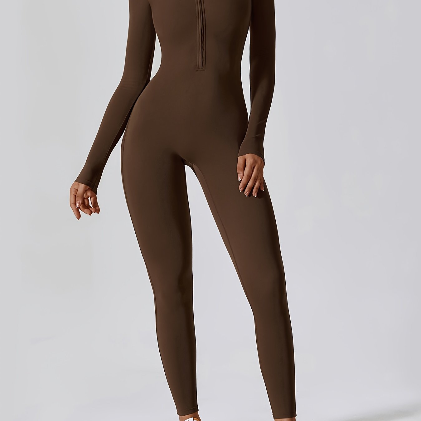 Long-sleeved yoga jumpsuit for women, solid color, slim fit.