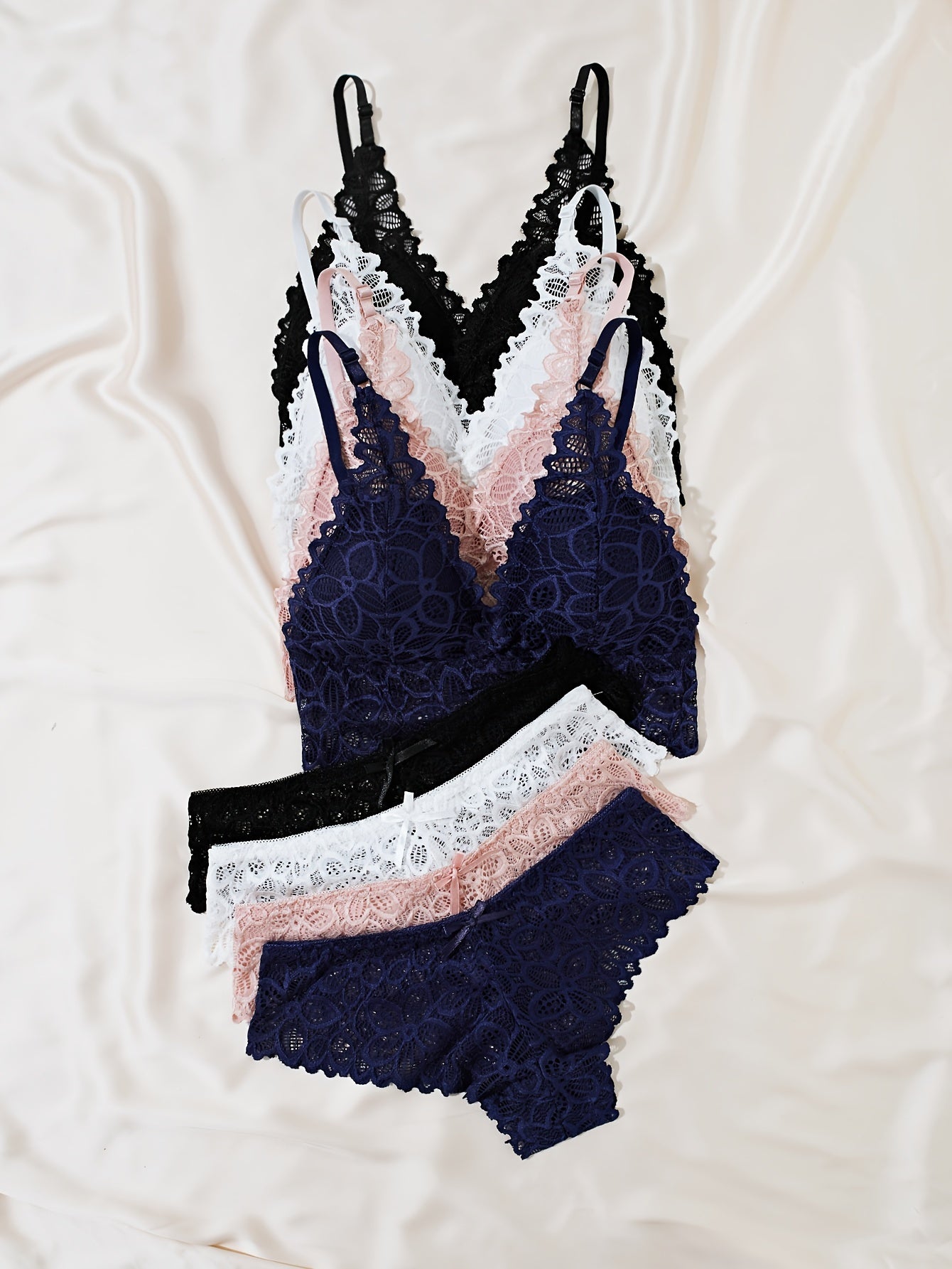 4 sets of women's lace lingerie in black, pink, navy, and white, available in sizes S, M, and L.