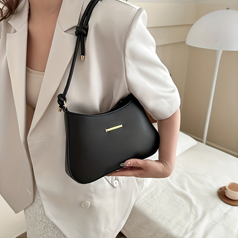 Black square handbag with zipper closure, crossbody style, edge paint detail.