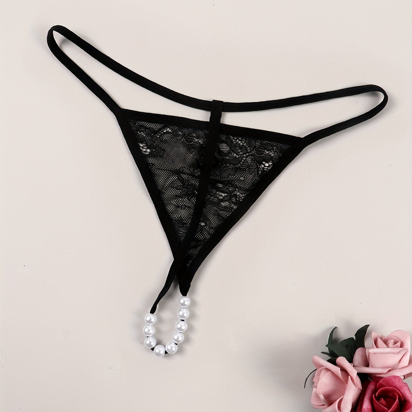 Sexy lace thong embellished with beads, transparent design for women.